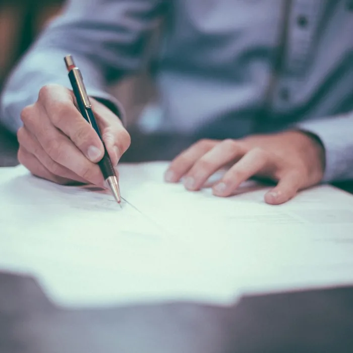 Signing a tax document at a desk
