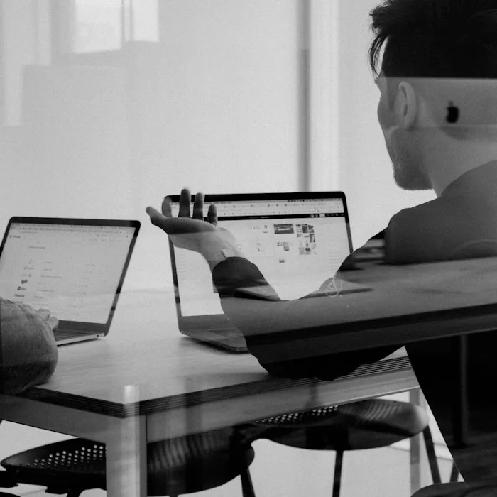 Two people reviewing plans on a laptop